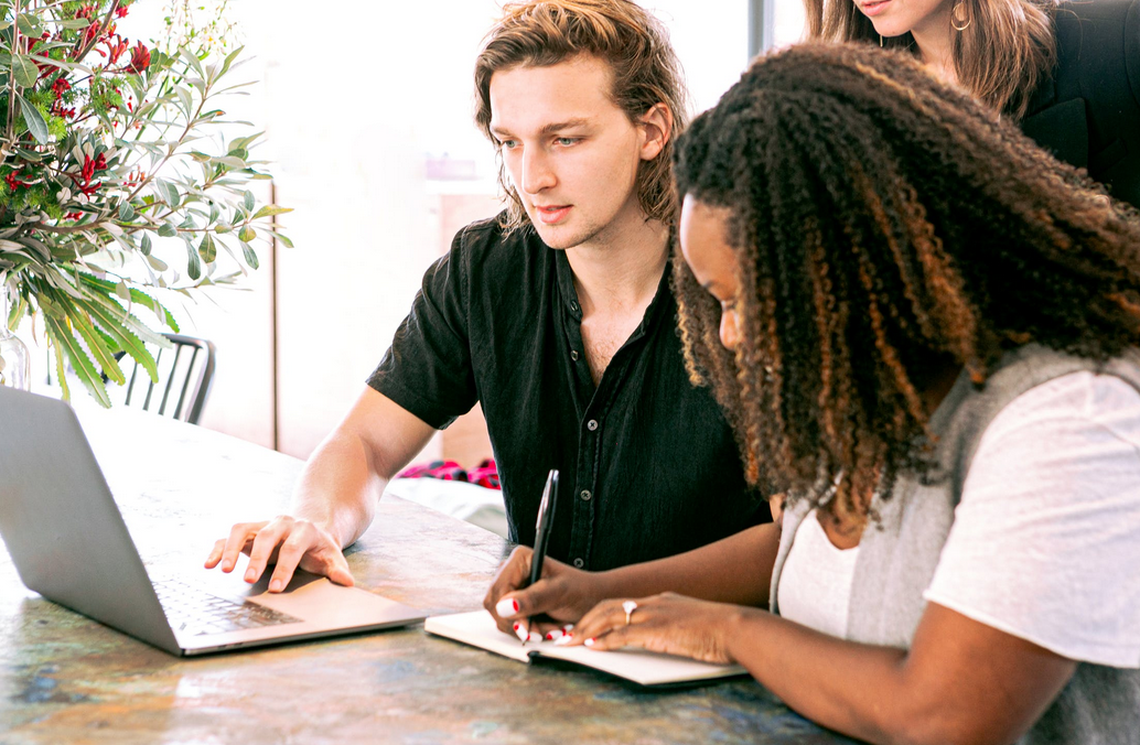 woman and man using laptop